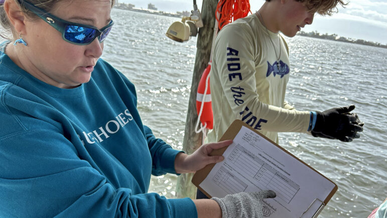 Krista Fleming, an environmental science teacher with Gulf Shores High School, explains what her class is doing with oyster gardens at the Little Lagoon Preservation Society’s oyster gardens in Gulf Shores, Alabama, on Feb. 9, 2024.