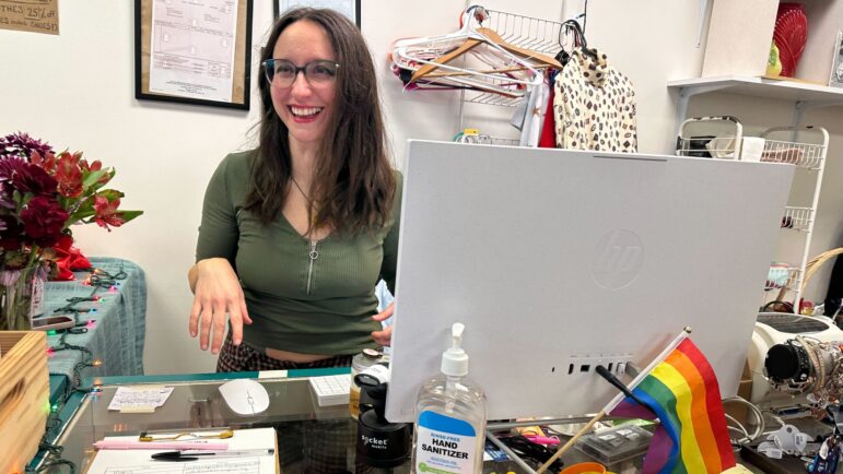 Sarah Randolph talks with customers during happy hour at rEVOLVEr resale, February 2024.