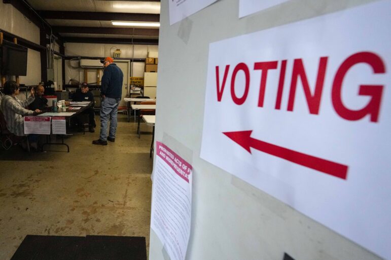 A voter prepares to vote at the volunteer fire station during a primary election.