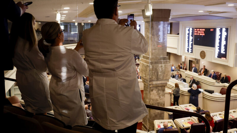 Doctors from the Alabama Fertility Clinic takes photos of the votes as the debate over the IVF fertility bill in the House Chambers is voted on.