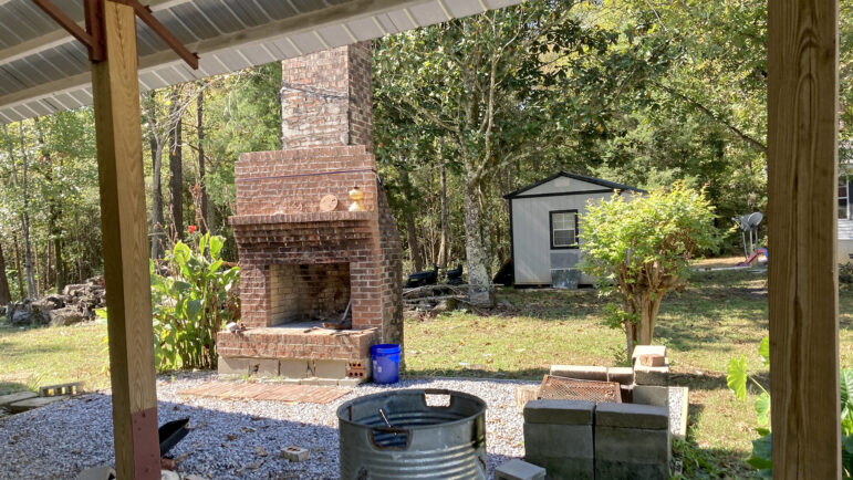 A brick fireplace sits on the property of Reggie Walker's home in Hale County, Alabama, on Oct. 18, 2023.