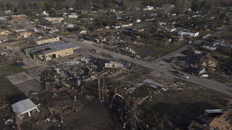 In this file photo, damage to homes and buildings is visible in Rolling Fork, Miss., after a tornado ripped through the community.