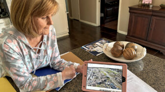 Terri Harden shows an aerial photo of the damage done to the mobile home park that she owned after an EF-4 tornado tore through Rolling Fork, Mississippi, last year on Saturday, March 23, 2024.