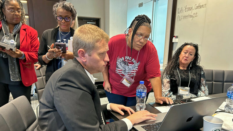 Former state legislator Roun McNeal (left) shows exoneree Sabrina Butler-Smith (center) the Mississippi legislature's website at an advocacy training in Ridgeland, Mississippi, on March 4, 2024.