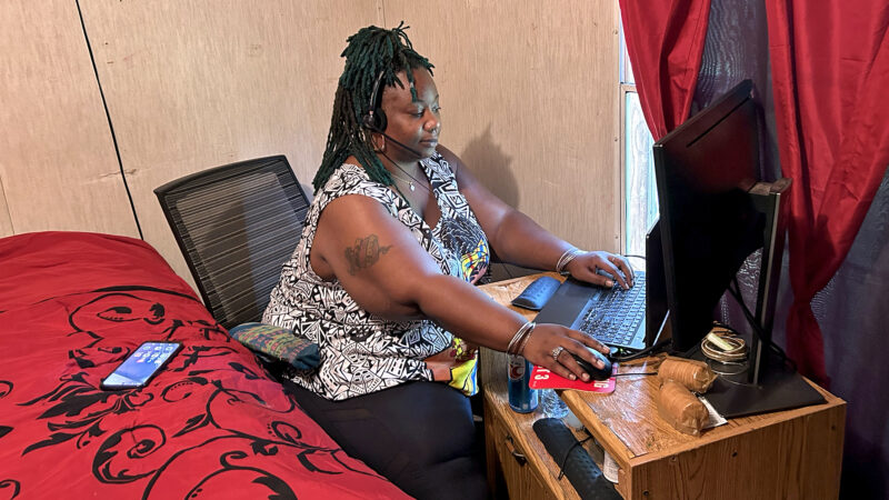 Lakeisha Preston logs into her work computer in her home on April 26, 2024, in New Hebron, Mississippi. Preston helps people enroll in Medicaid but cannot do so herself because she falls into the coverage gap in Mississippi.
