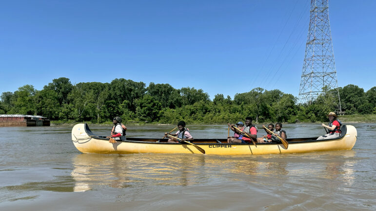 Teenagers and younger kids with Spring Initiative, an after-school program in Clarksdale, Mississippi, make their way down the Mississippi River in Helena, Arkansas, on Saturday, May 11, 2024.