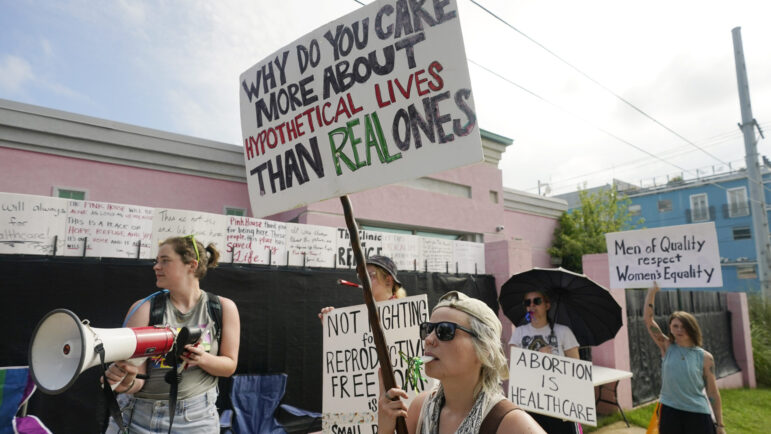 Abortion rights advocates stand outside the Jackson Women's Health Organization clinic in Jackson, Miss., and attempt to shout down a group of abortion opponents, on Thursday, July 7, 2022.