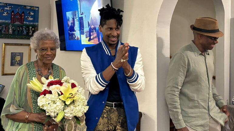 Danella Johnson (left) poses for photos with Jon Batiste (middle) and her son Barry Johnson (right) inside The Ballard House in Birmingham, Alabama.