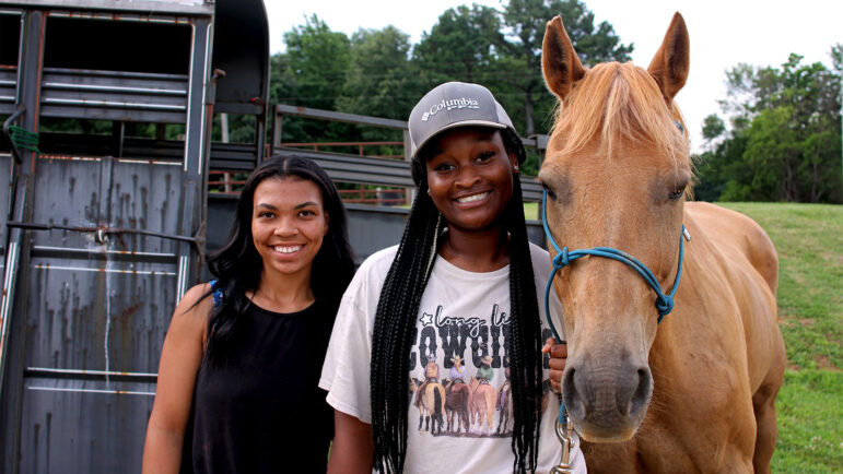 Brenna-Kate Keys (left) and Khyanna Moore (right) stand with Brenna-Kate’s horse, Buddy before the Pontotoc Juneteenth Horse Show on June 19, 2024.