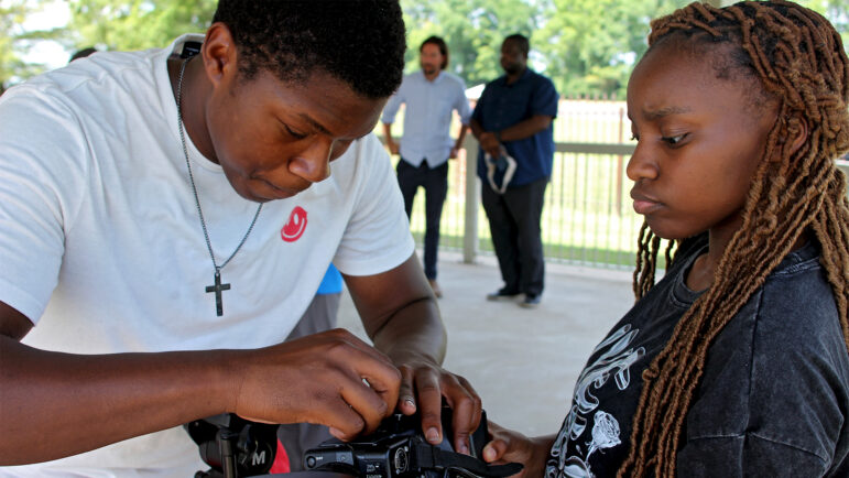 Nicholas Williams and Amari Smith troubleshoot with their digital camera while at the Fannie Lou Hamer Memorial Garden in Ruleville, Mississippi, on June 21, 2024.