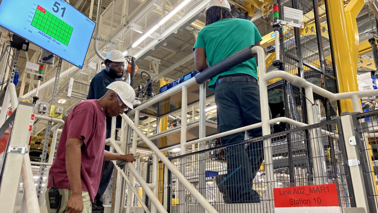 Mercedes-Benz employees work the line at the Vance, Alabama plant on August 25, 2023.