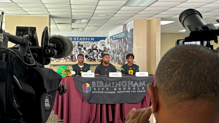 P.D. Jackson-Olin High School football player Ayyden Moody (left), head coach Joe Webb (center), and player Joel Ray (right) answer questions at Birmingham City School’s Media Day before the start of the football season on Aug. 8, 2024.