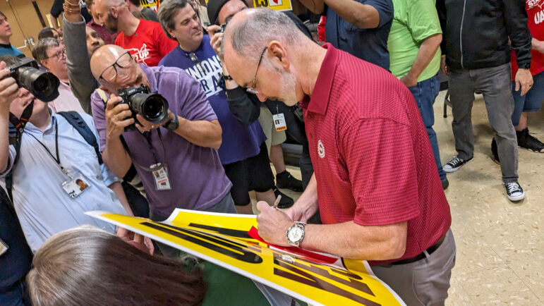 UAW President Shawn Fain signs a “Union Yes” poster after Volkswagen workers in Tennessee vote to unionize on April 19, 2024.