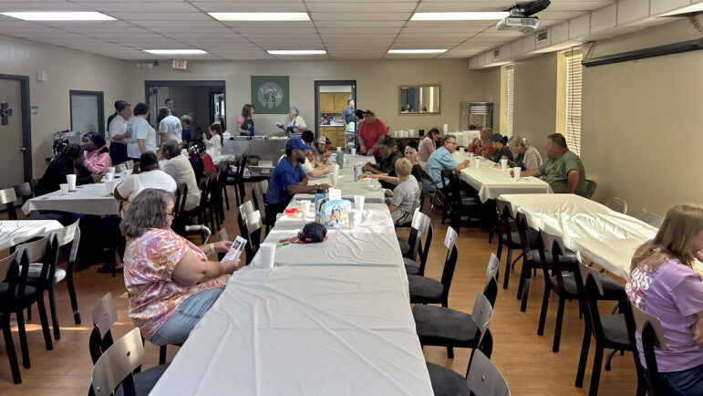 Families eat dinner at Locust Grove Baptist Church in New Market, Alabama, on August 22, 2024, as they wait to learn more about a new pilot program that gives some opioid settlement money directly to grandparents raising their grandchildren.