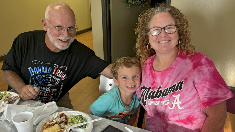 Jeff and Donna Standridge enjoy a spaghetti dinner with one of their grandsons at Locust Grove Baptist Church in New Market, Alabama, on August 22, 2024.