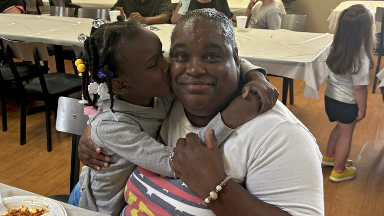 Lisa Hill gets a big kiss on the cheek from her granddaughter, Kayla, at Locust Grove Baptist Church in New Market, Alabama, on August 22, 2024.