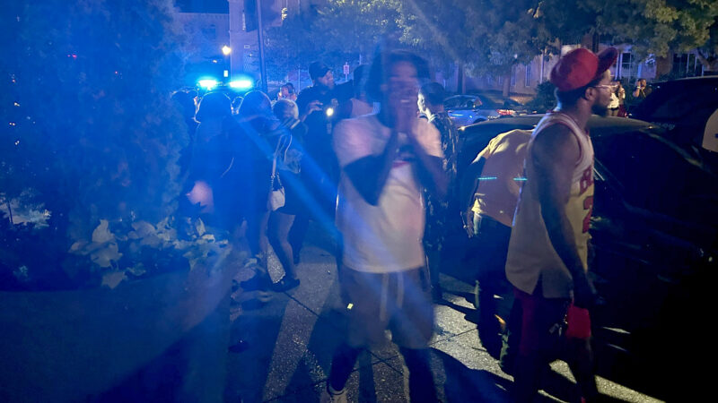 A group of people move away from the scene of mass shooting in the 2000 block of Magnolia Avenue South on Saturday, Sept. 21, 2024.