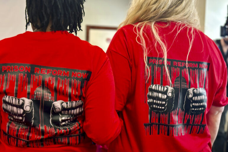 Family members of people incarcerated in the Alabama prison system wear shirts calling for reform during a Legislative Prison Oversight Committee meeting.