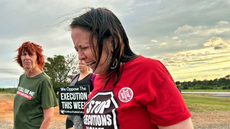 Demonstrator Tish Warr weeps at a vigil protesting the execution of Alan Miller in Atmore, Alabama, as other protestors look on, Sept. 26, 2024.