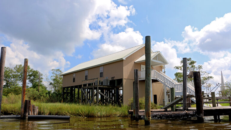 An elevated house sits on the edge of the water in Port Sulphur, Louisiana, on Sept. 20th, 2024.