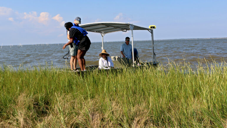 The Gulf States Newsroom's Drew Hawkins and Danny McArthur get out of a boat to explore the Lemon Tree Mound on Sept. 20, 2024.