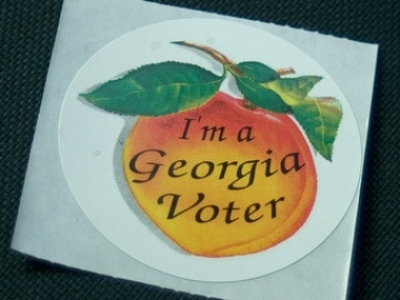 https://wbhm.org/wp-content/uploads/2024/10/ga_voter_sticker_moriah_via_flikr_7.jpg