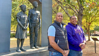 Lamar Lawrence and Chris Anderson, of 100 Black Men of Metro Birmingham, pose for a portrait on Oct. 19, 2024, in front of a statue commemorating the Birmingham Children's Crusade during the Civil Rights Movement.