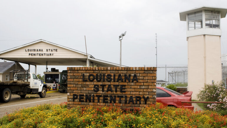 In this file photo, vehicles enter at the main security gate at the Louisiana State Penitentiary — the Angola Prison, the largest high-security prison in the country — in Angola, La., Aug. 5, 2008.