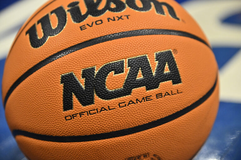 An official game ball sits on the court during the second half of an NCAA college basketball game between Southern California and UCLA.