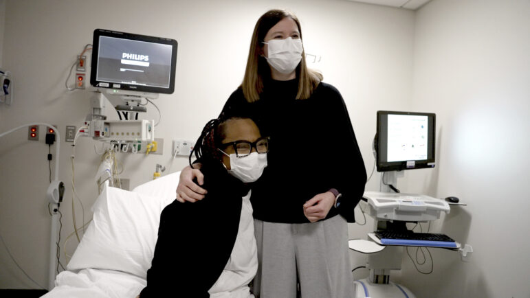 Pig kidney recipient Towana Looney sits with transplant surgeon Dr. Jayme Lock.