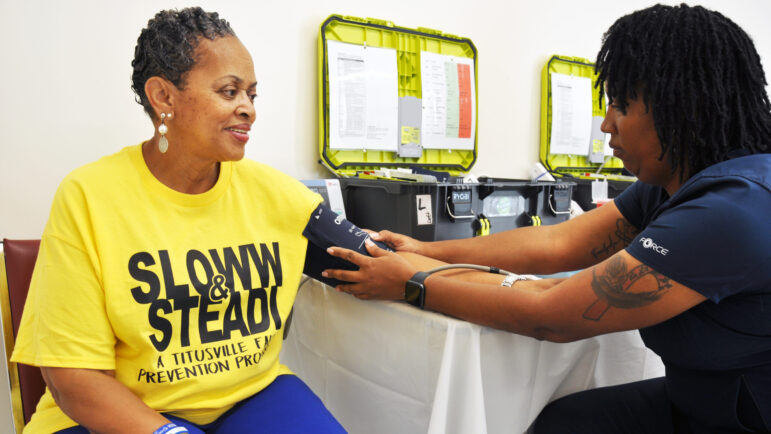 Keisha Taylor, a UAB clinical research coordinator, takes Laura Dudley's blood pressure as part of a Mobile Wellness clinic event held in conjunction with the Titusville Senior Wellness Expo.