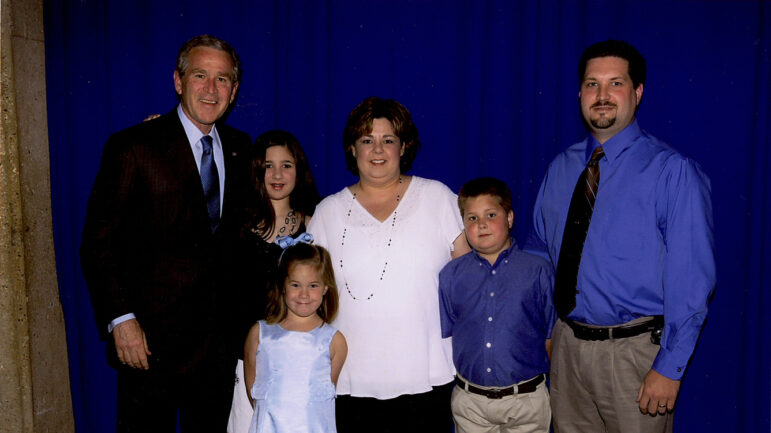 Former President George W. Bush stands with the Malosh family just before Bush spoke at Tracy’s commencement ceremony when she graduated from nursing school at Mississippi Gulf Coast Community College in Biloxi, Mississippi, on May 11, 2006.