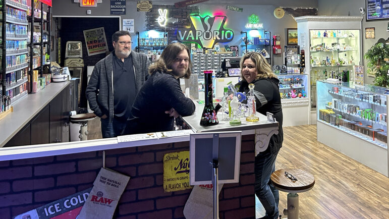 (left-right) Charles, Trevor, and Tracy Malosh sit in their family store in Ocean Springs, Mississippi, on Dec. 20, 2024.