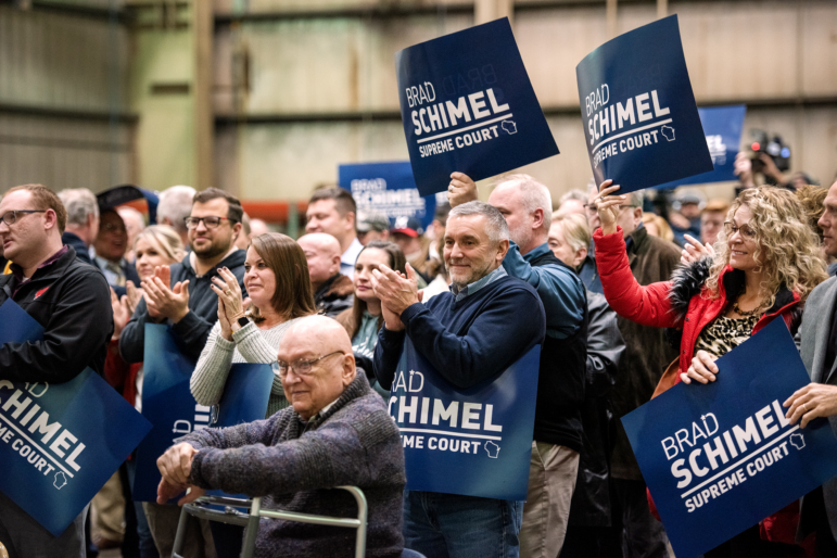 Attendees applaud as Brad Schimel announces his run for Wisconsin State Supreme Court on Thursday, Nov. 30, 2023, in Waukesha, Wis.