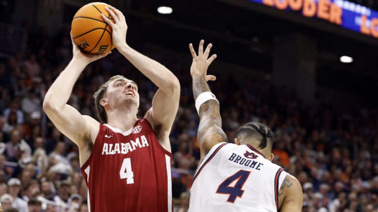 Alabama forward Grant Nelson shoots over Auburn forward Johni Broome during the first half of an NCAA college basketball game.