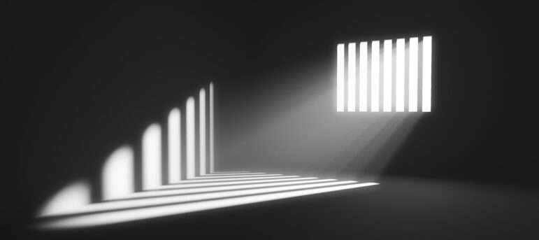 Light behind prison cell bars
