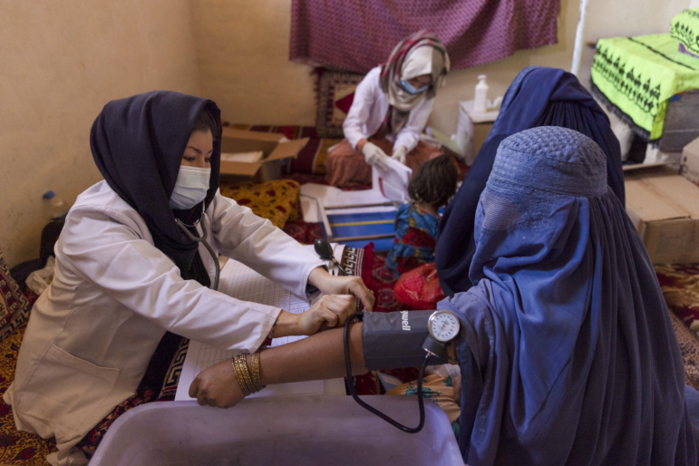 A midwife assesses a pregnant woman at a mobile health clinic in Bagrami District, Kabul Province, Afghanistan, on Monday, Oct. 31, 2022. Afghanistan's economy has been in free fall since Taliban takeover of power August last year after an abrupt cut in international aid, which accounted for 40% of its gross domestic product and 75% of total government spending, and the UN says more than half the country's population or 20 million are facing acute hunger.