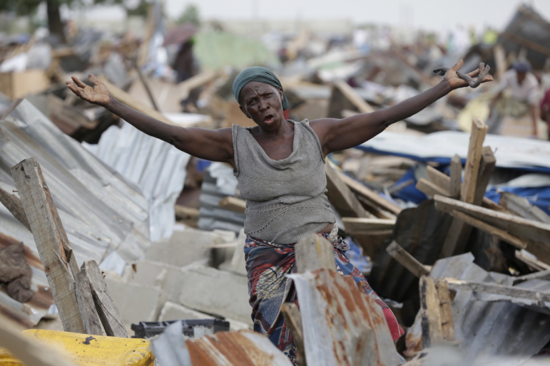 A woman gestures in front of her demolished house in Otodo-Gbame waterfront in Lagos, Nigeria. Saturday, March 18, 2017. Slums and shantytowns are often targeted in rampant demolitions across Africa’s most populous country