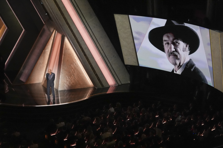 Morgan Freeman speaks about Gene Hackman with an image of Gene Hackman on the screen during the 2025 Oscars.
