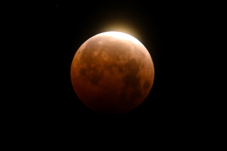 Light shines from a total lunar eclipse over Santa Monica Beach in Santa Monica, Calif., on May 26, 2021.