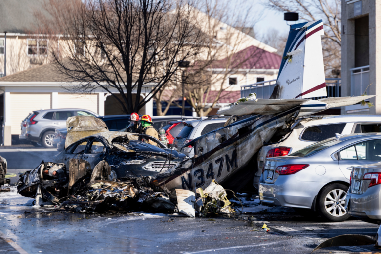 First responders work the scene after a plane crashed in the parking lot of a retirement community in Manheim Township, Pa. on Sunday.