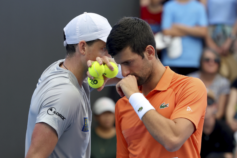 Canada's Vasek Pospisil and Serbia's Novak Djokovic talk tactics during their double match against during their Round of 32 match at the Adelaide International Tennis tournament in Adelaide, Australia, Jan. 2, 2023.