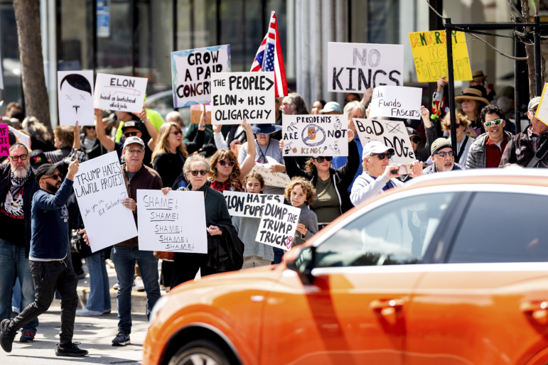 Protesters rally against Tesla CEO Elon Musk outside a Tesla store in San Francisco on Saturday.