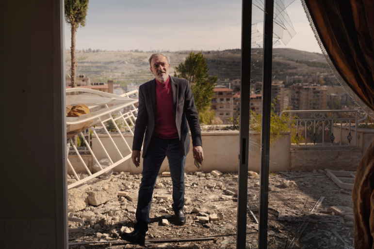 Ghassan Mamouli, a representative from the Damascus government, inspects the damage at the site of an Israeli airstrike on Thursday.