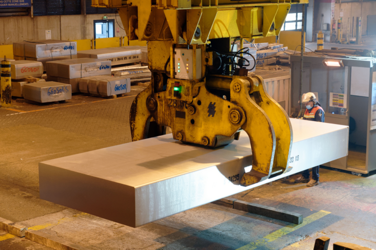 A worker manipulates a block of aluminum in a French smelter in 2022.