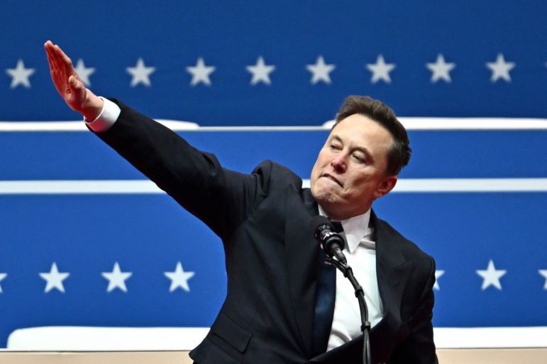 Elon Musk salutes as he speaks during an inaugural event in Washington, DC, on Jan. 20, 2025.