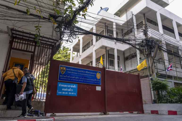 Police enter an immigration detention centre in Bangkok on Jan. 22.