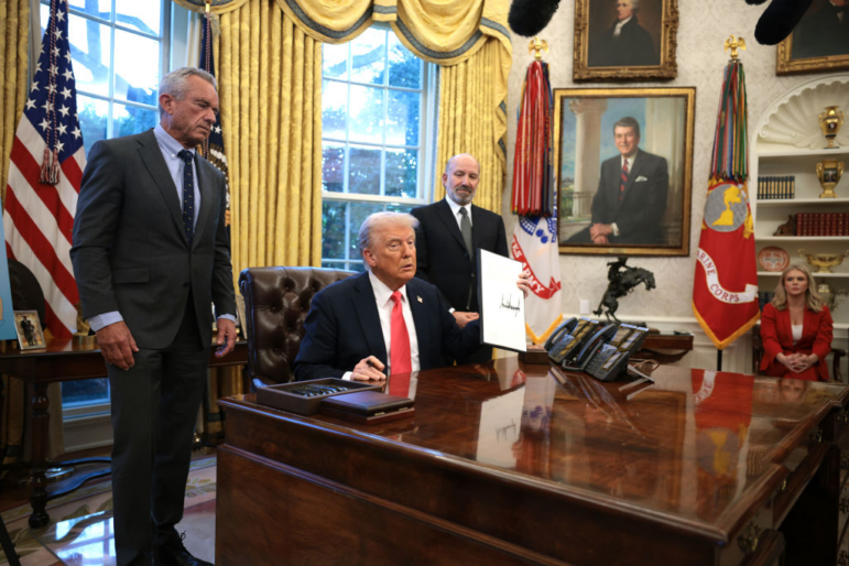 President Donald Trump, joined by Health and Human Services Secretary Robert F. Kennedy Jr. (L) and Commerce Secretary Howard Lutnick (R), signs an executive order on February 25, 2025 on price transparency requirements for the health care industry.