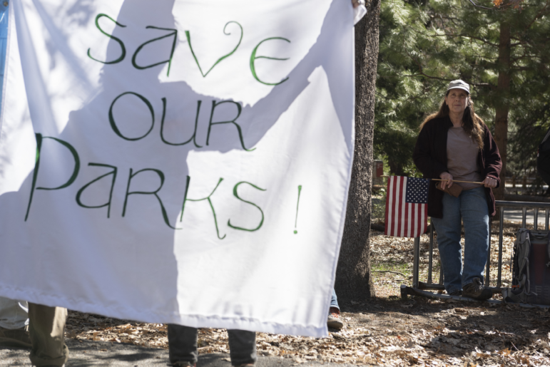 People protest the mass layoffs of federal employees at Yosemite National Park on March 1, 2025. Many workers at the U.S. Department of Interior and other agencies are being reinstated following court orders.