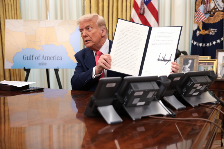President Trump signs executive orders in the Oval Office on March 6, including the order terminating the security clearances of those who work at the law firm Perkins Coie.